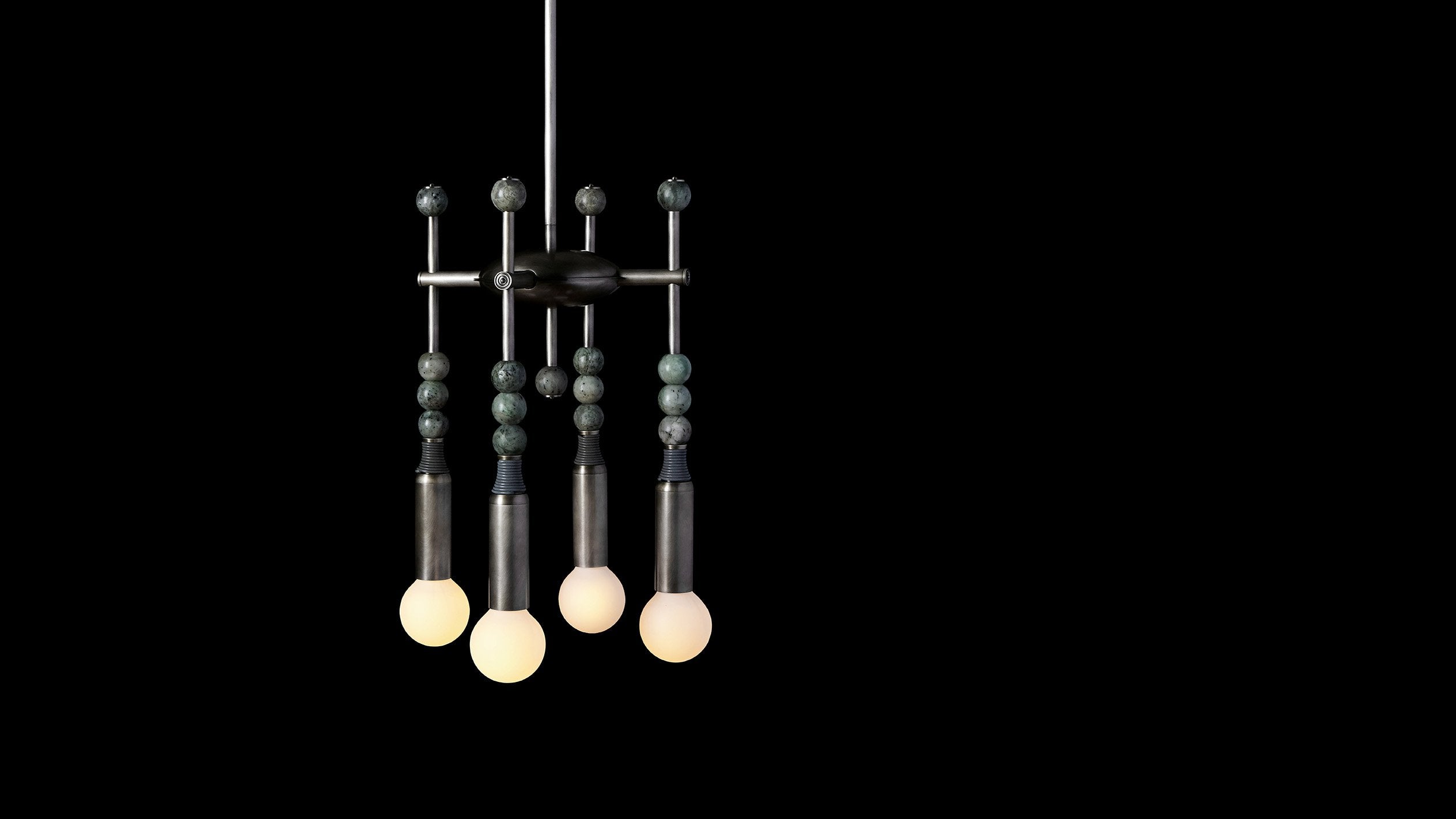 TALISMAN : 4 chandelier in Tarnished Silver and Cool Gray Leather with Jade stone, against a black background. 