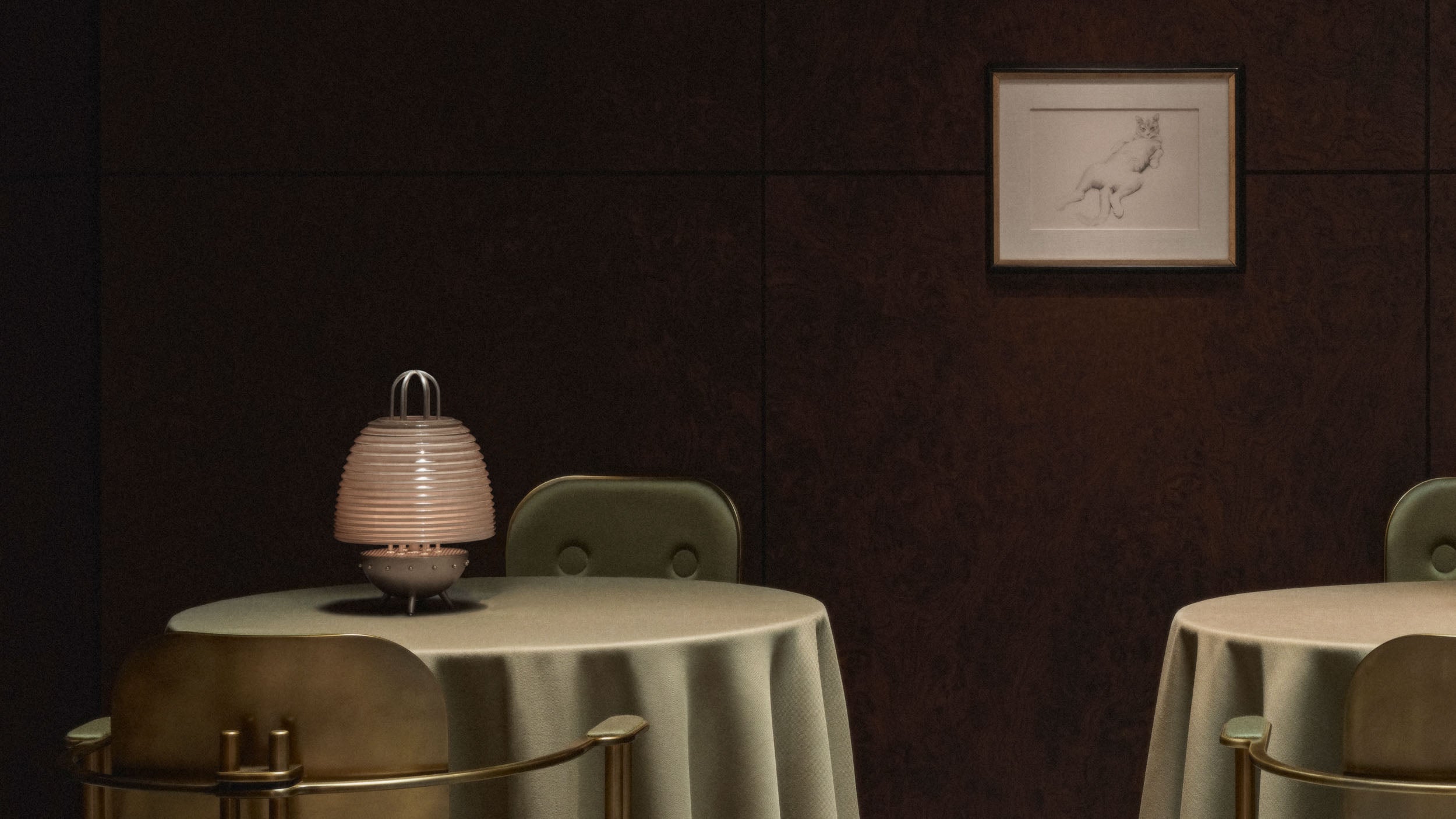 A SIGNAL : X table lamp is on a small circular table with EPISODE arm chairs either side. 