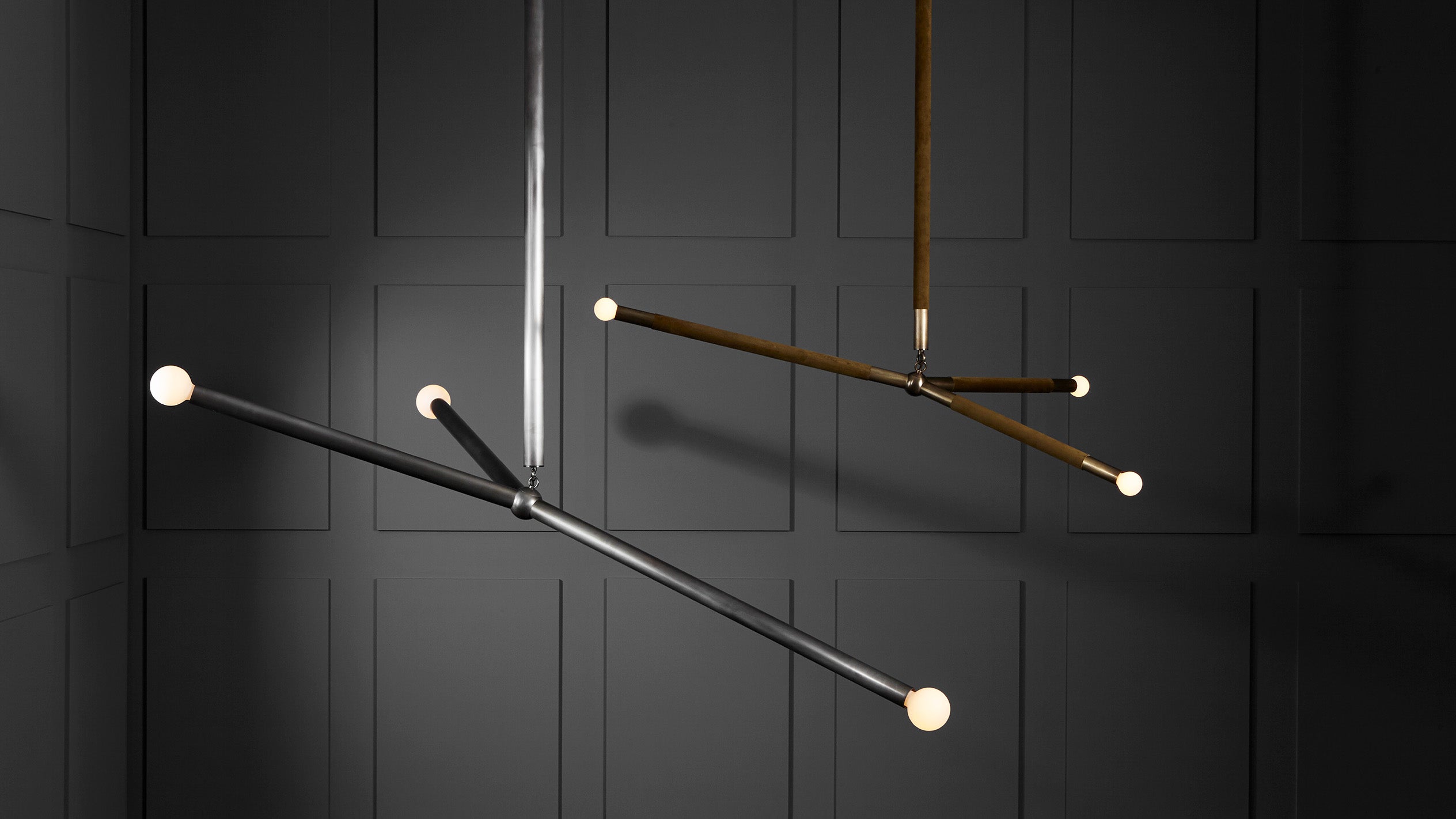 A pair of ARROW ceiling pendants in an assortment of sizes and metal finishes. 