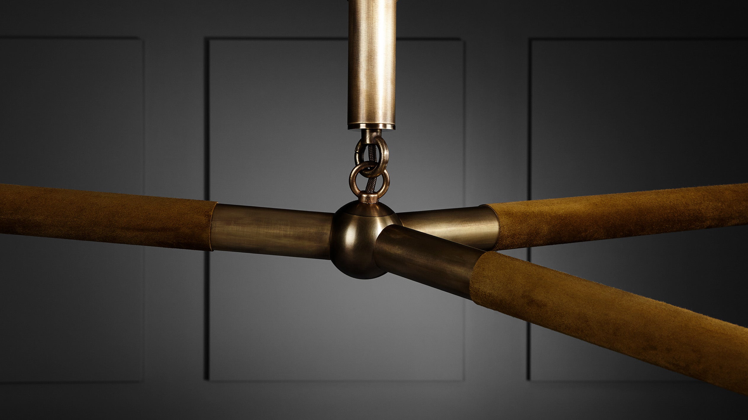 Close up of ARROW ceiling pendant showing details of the Aged Brass finish and Bronze Suede. 