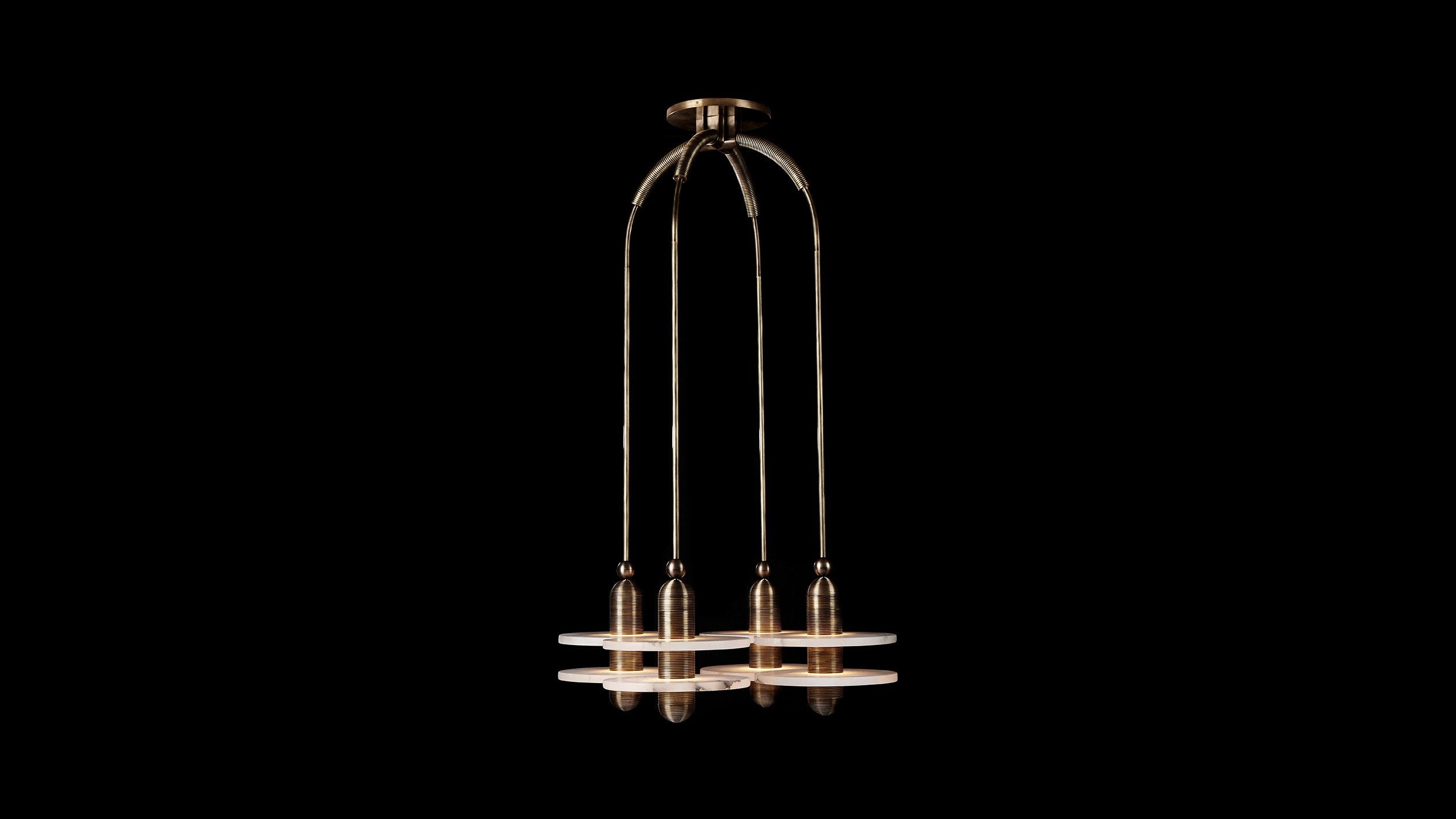 MEDIAN : 4 ceiling pendant in Aged Brass finish, hanging against a black background. 