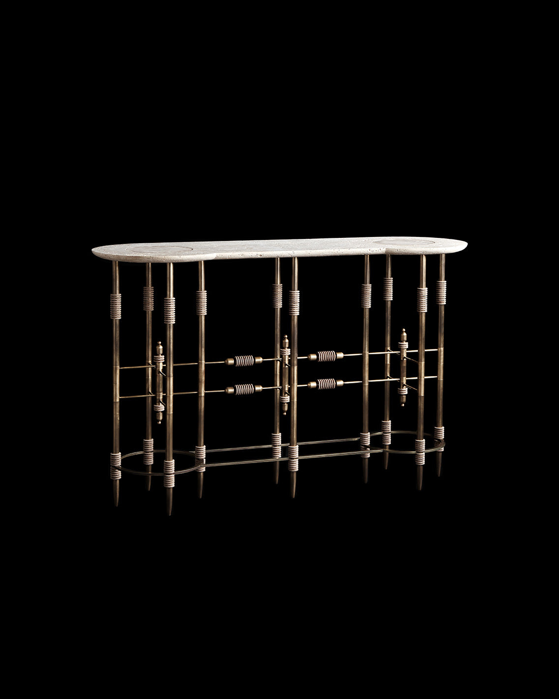 PARS console table in Aged Brass with Travertine Stone and Bisque Leather, against a black background. 