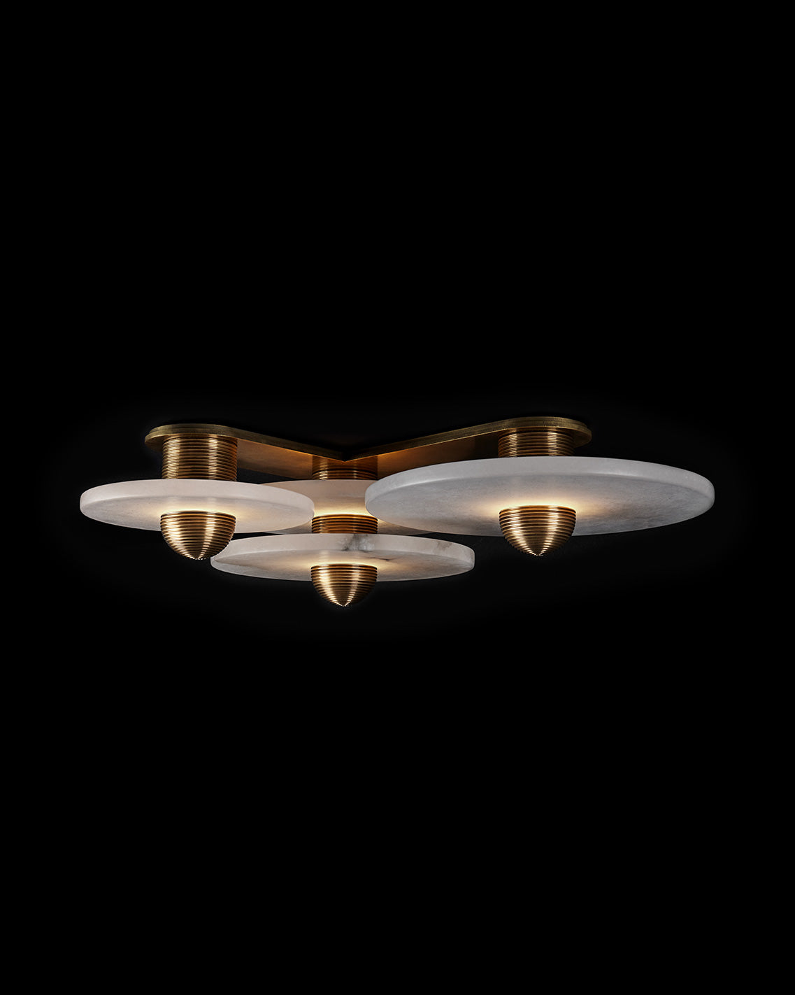 MEDIAN : 3 surface light in Aged Brass finish, mounted to a black ceiling. 