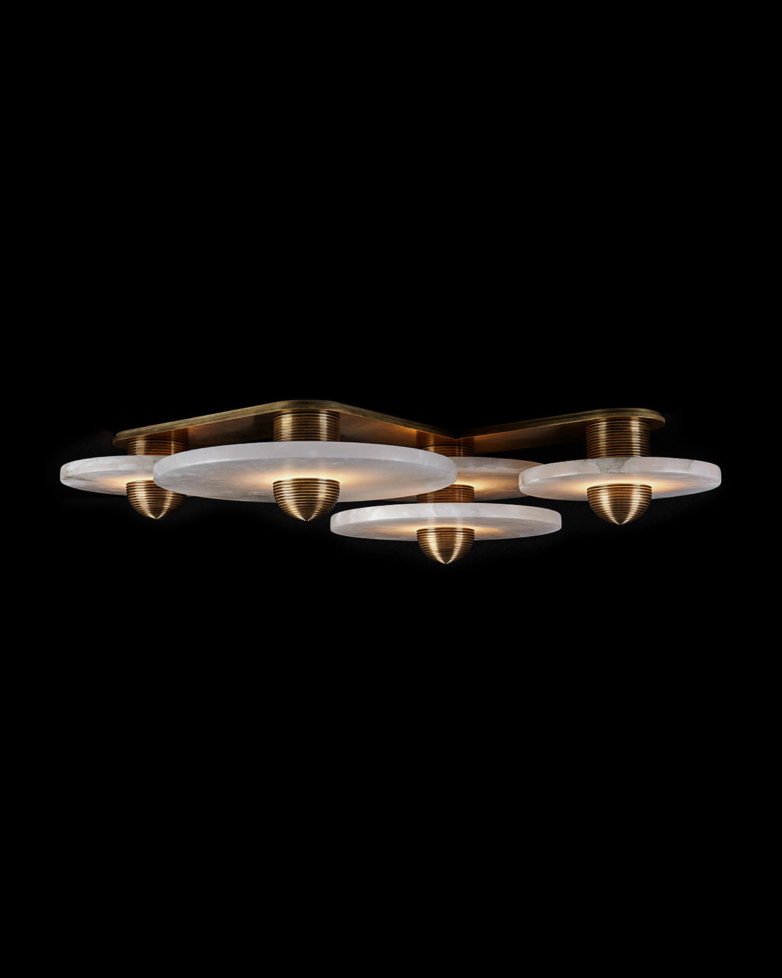 MEDIAN : 4 surface light in Aged Brass finish, mounted to a black ceiling. 