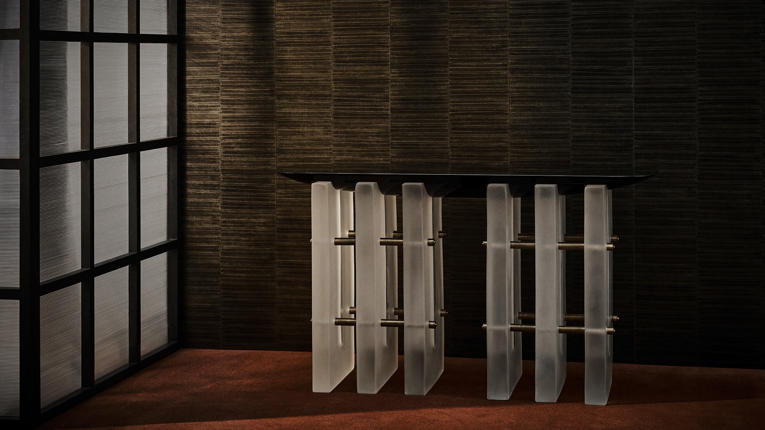 SEGMENT console table in Black Lacquer next to a window. 