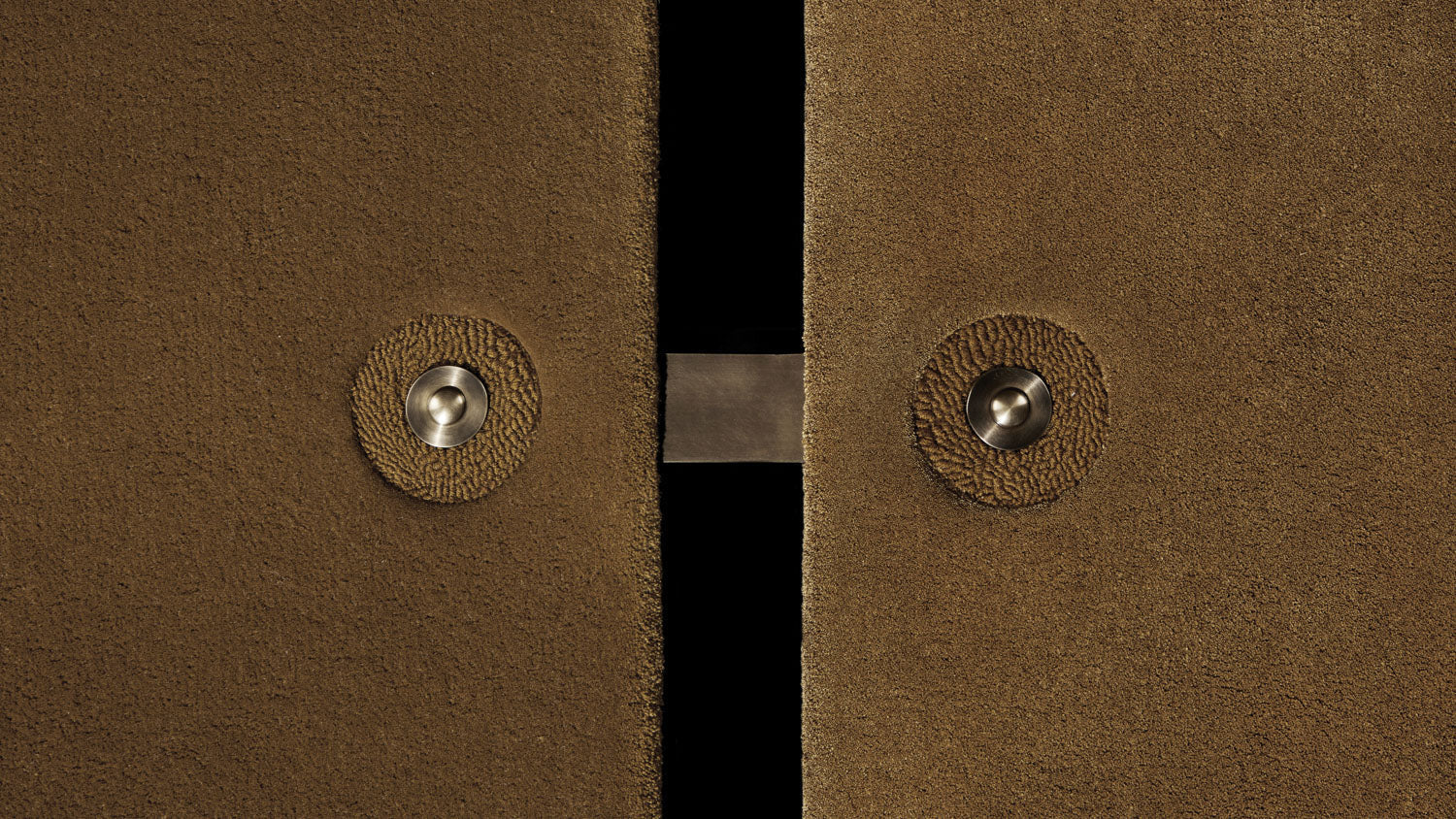 Close up of a modular SEQUENCE rug showing details of the Bronze wool, Bronze silk and Aged Brass metal finish.