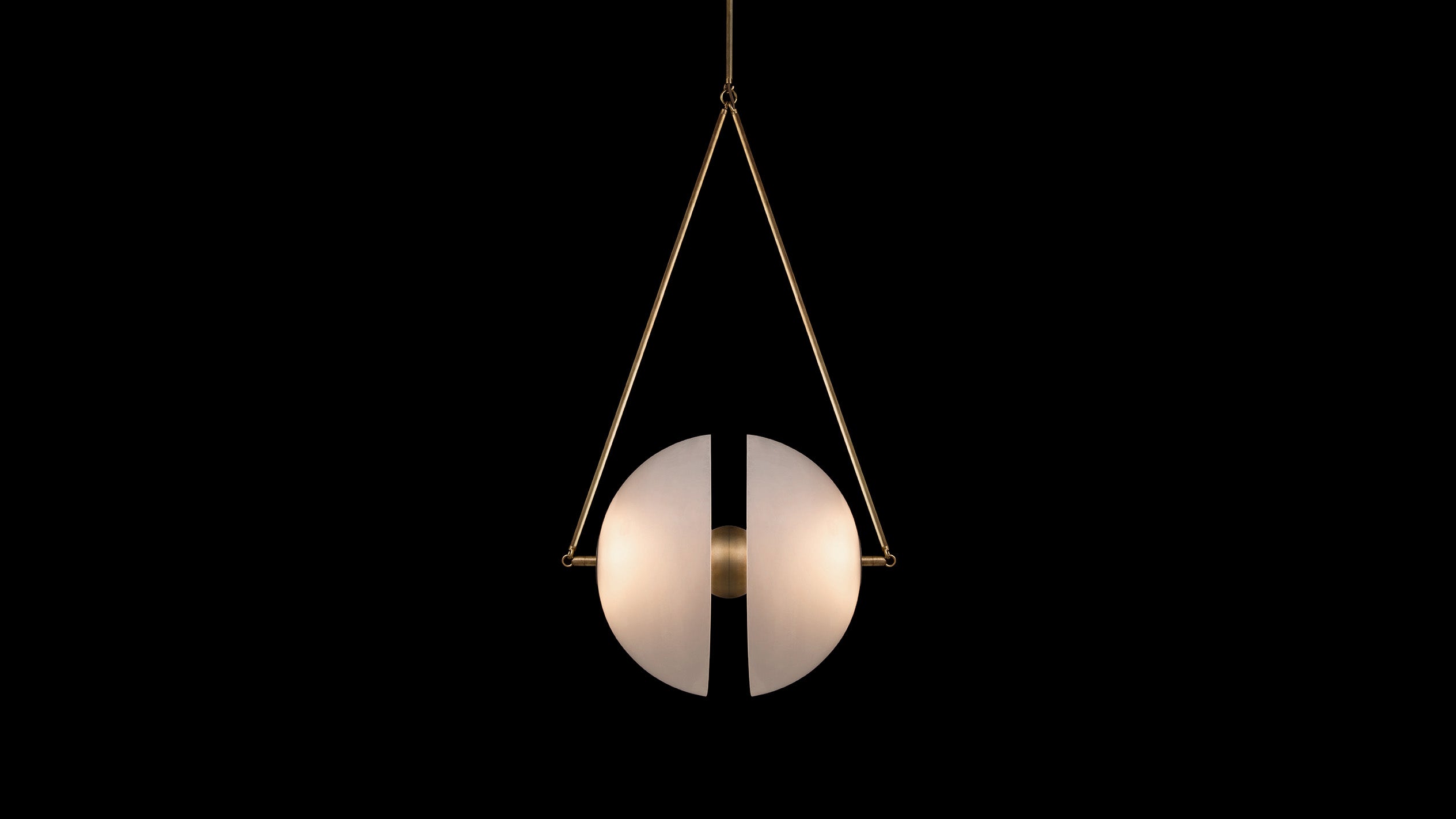 SYNAPSE ceiling pendant in Aged Brass finish, hanging against a black background. 