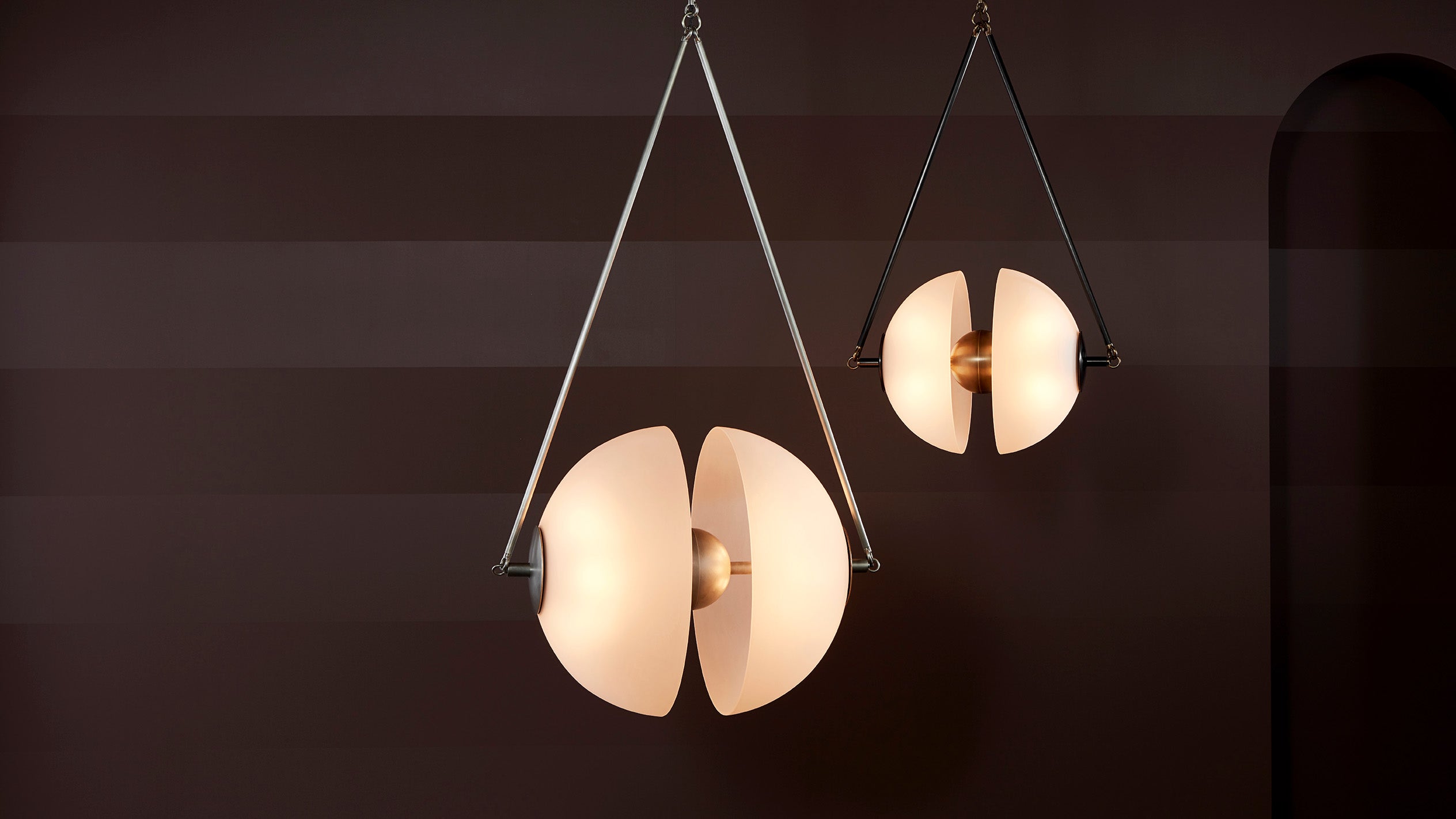 A pair of SYNAPSE ceiling pendants in an assortment of sizes and metal finishes. 