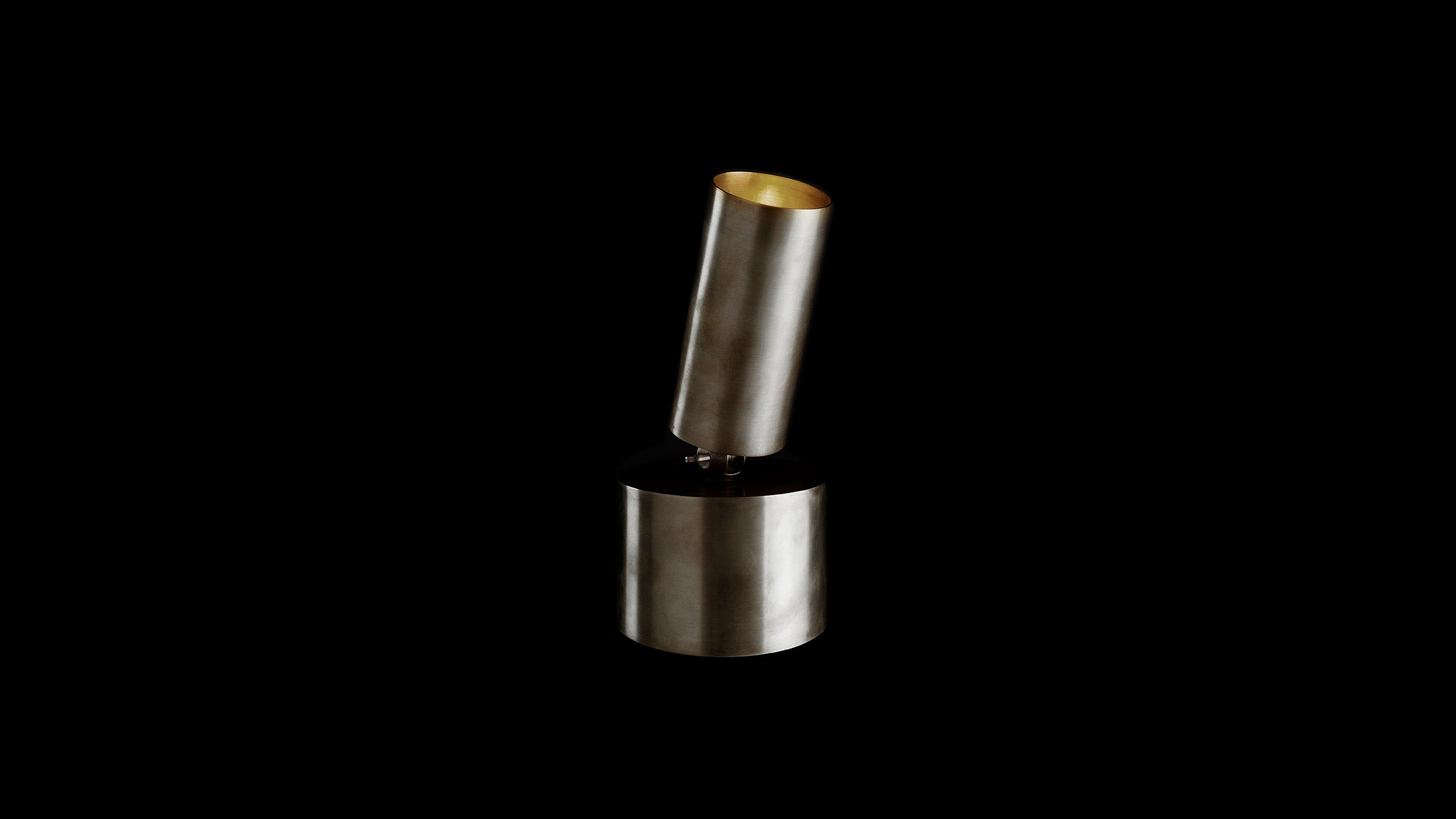 CYLINDER directional table lamp in Tarnished Silver finish, against a black background. 