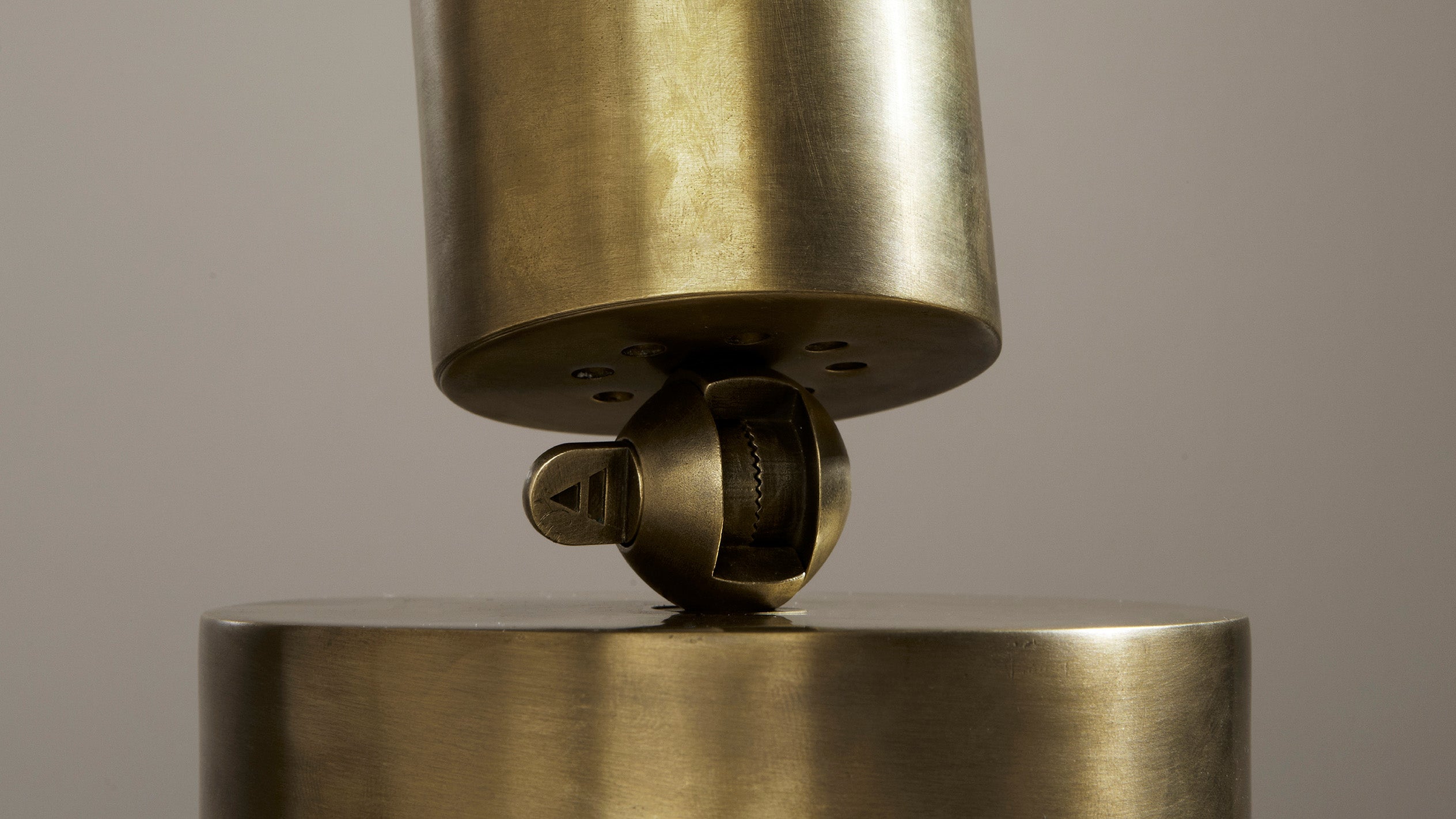 Close up of CYLINDER : UPLIGHT showing details of the Aged Brass finish. 