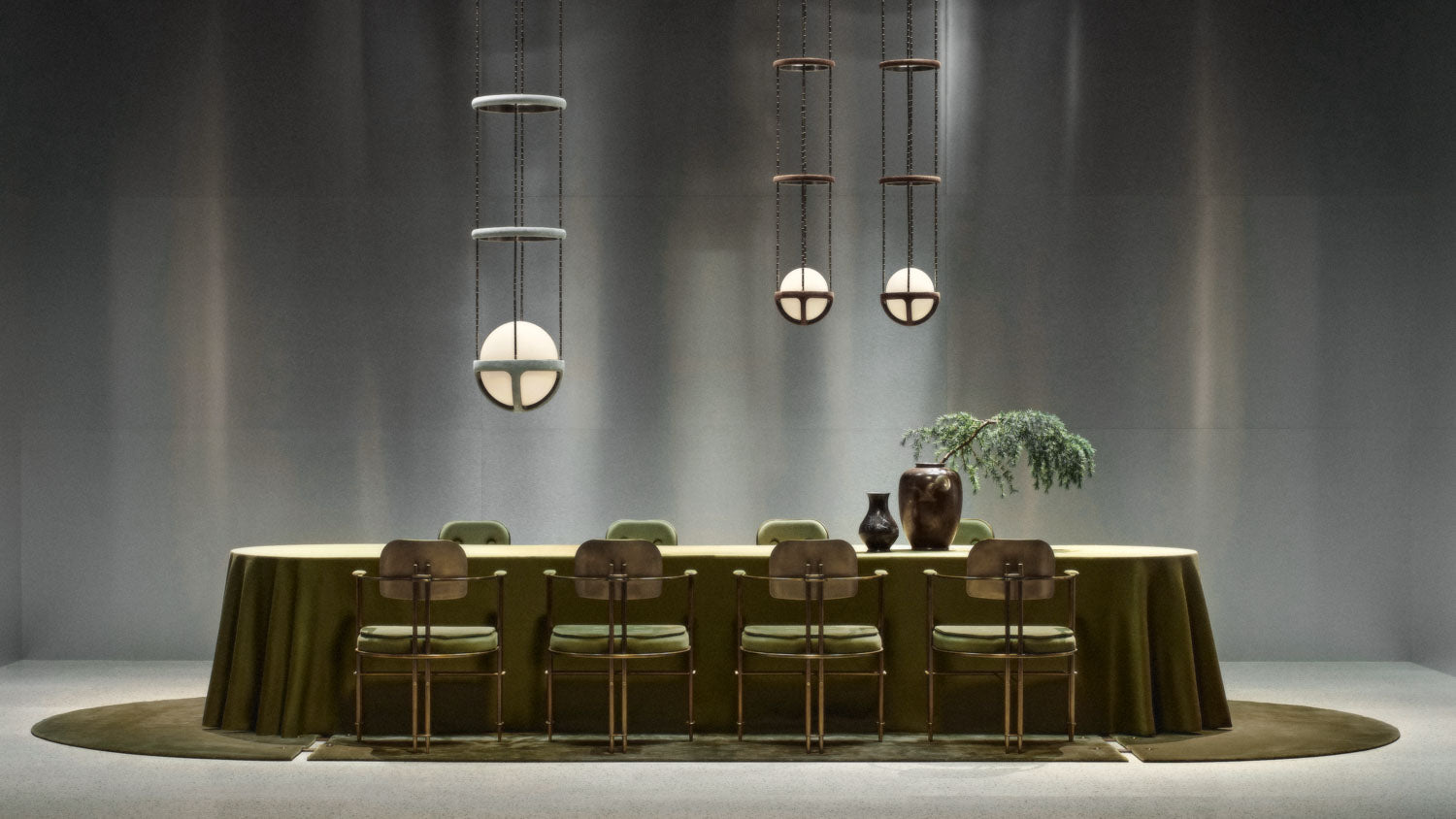 Eight EPISODE armchairs surround a decorated table, beneath three REPRISE ceiling pendants.