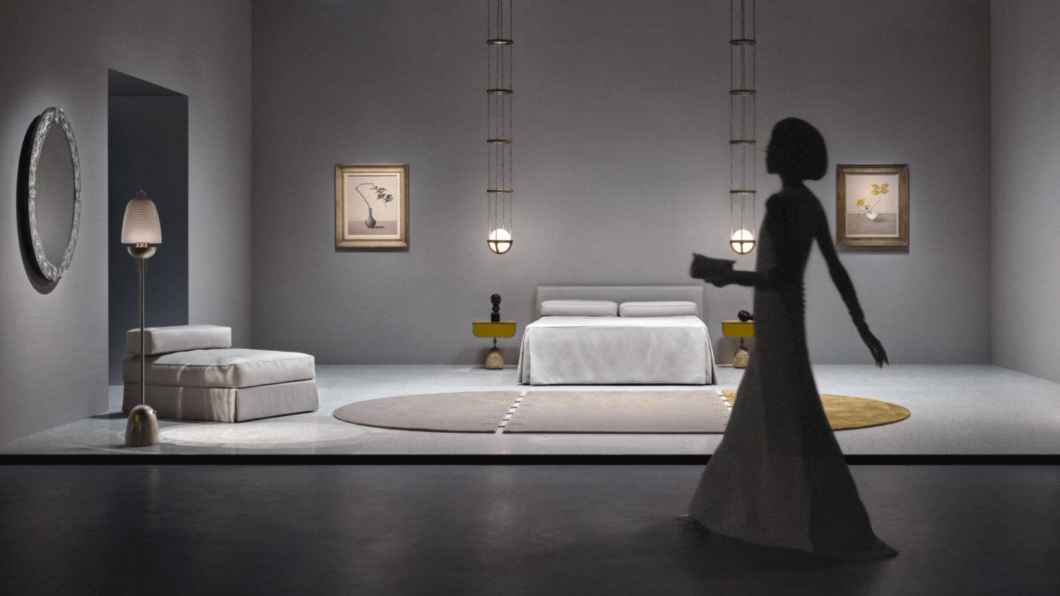 A woman walks past a bedroom set, where two REPRISE ceiling pendants hang either side of a bed. 