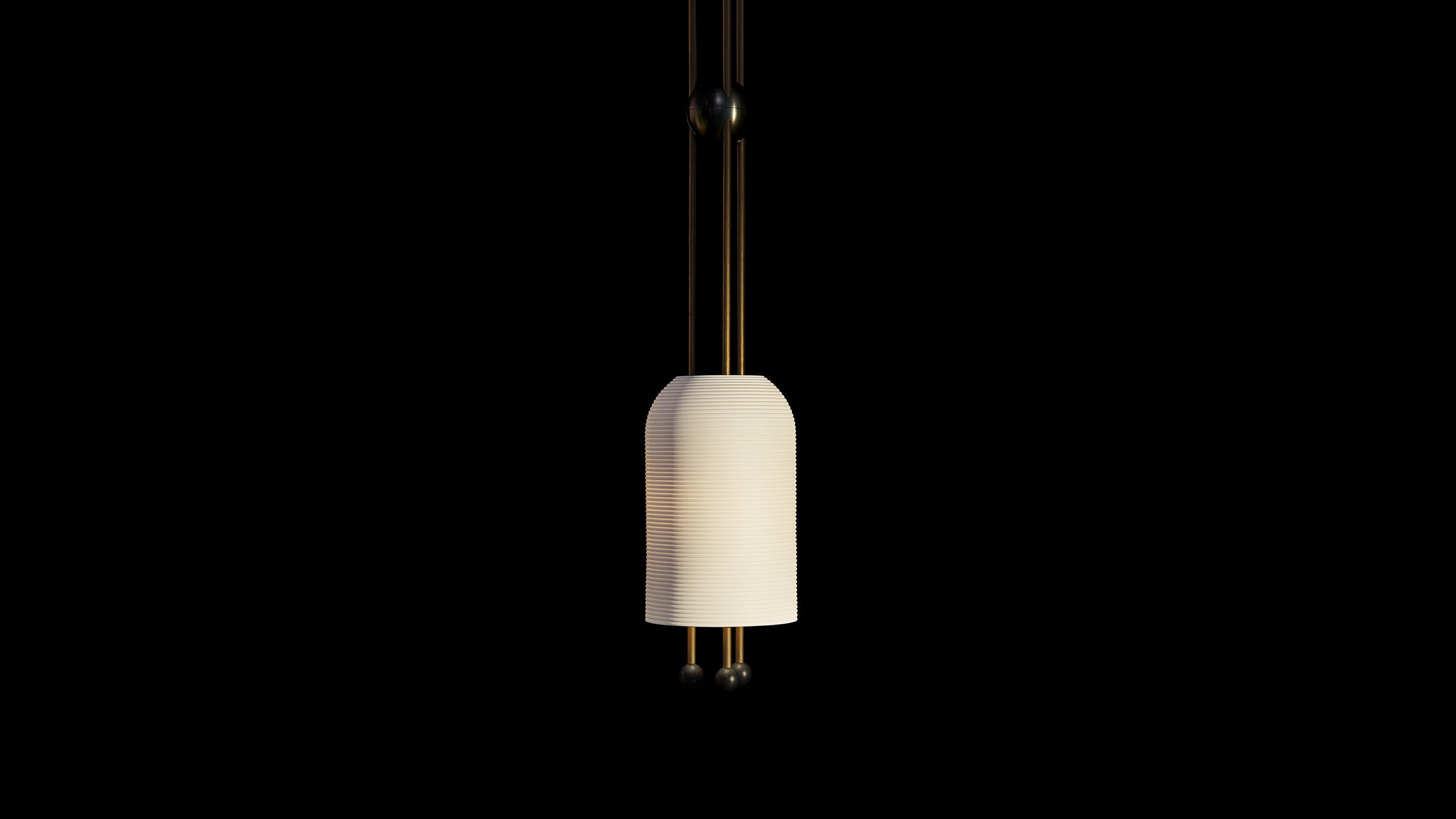 LANTERN ceiling pendant in Aged Brass and Blackened Brass finish hanging against a black background. 