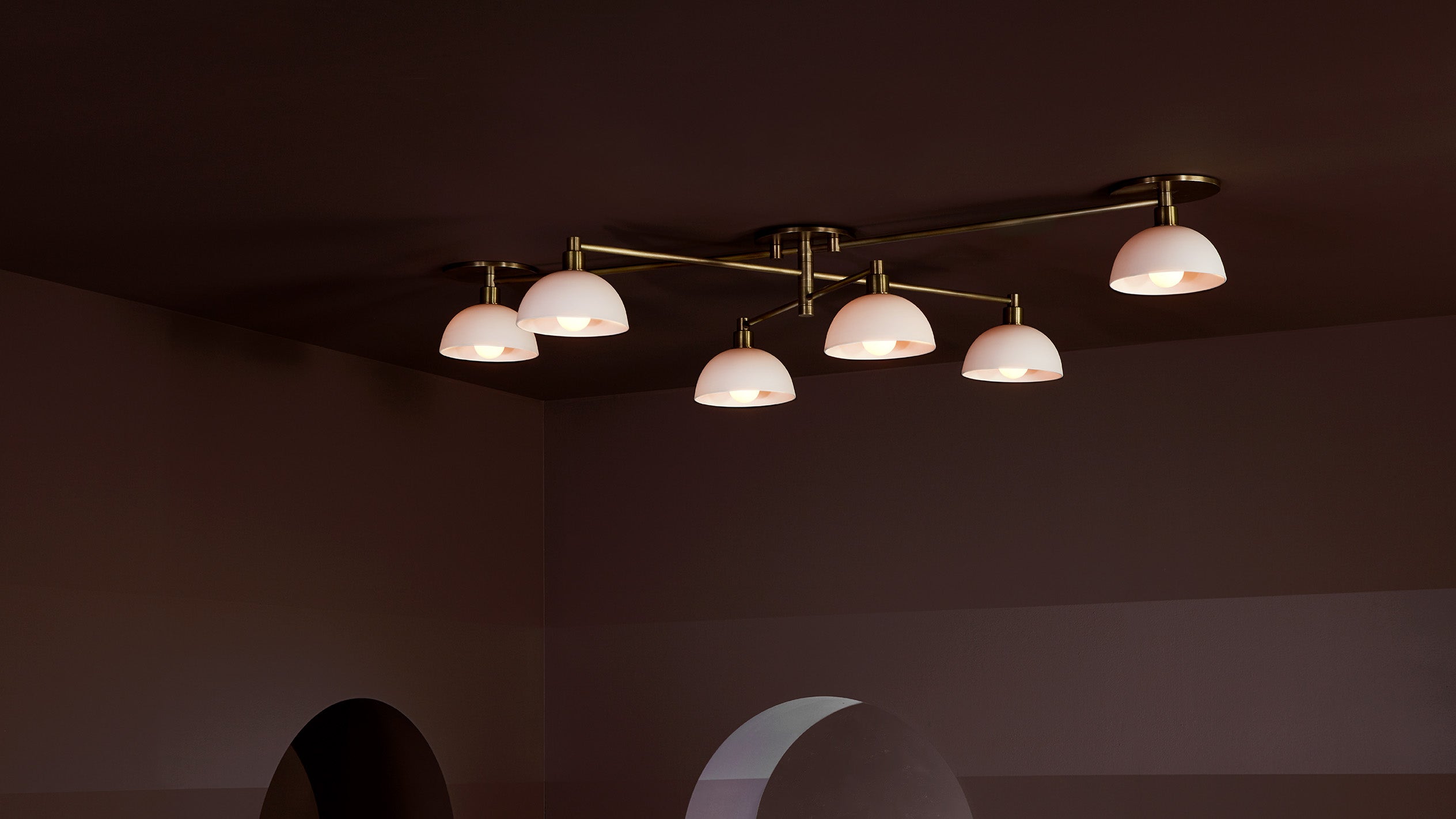 An illuminated TRAPEZE : 6 surface light mounted to a ceiling. 