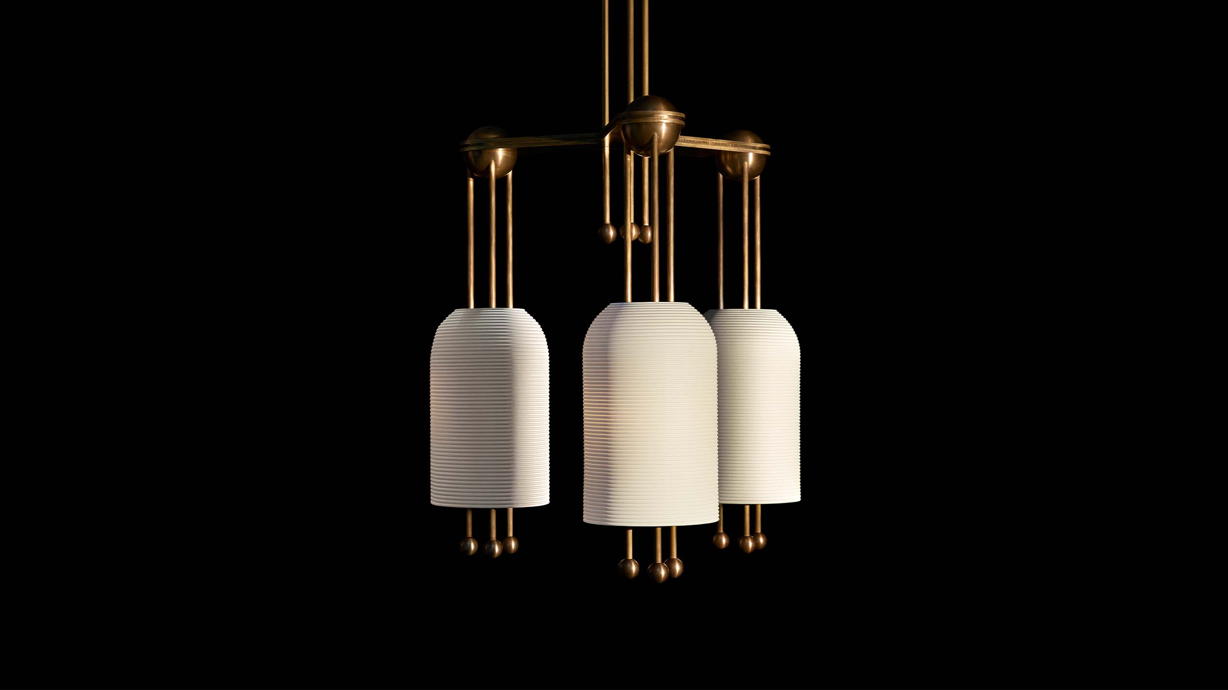 LANTERN : 3 ceiling pendant in Aged Brass finish hanging against a black background. 