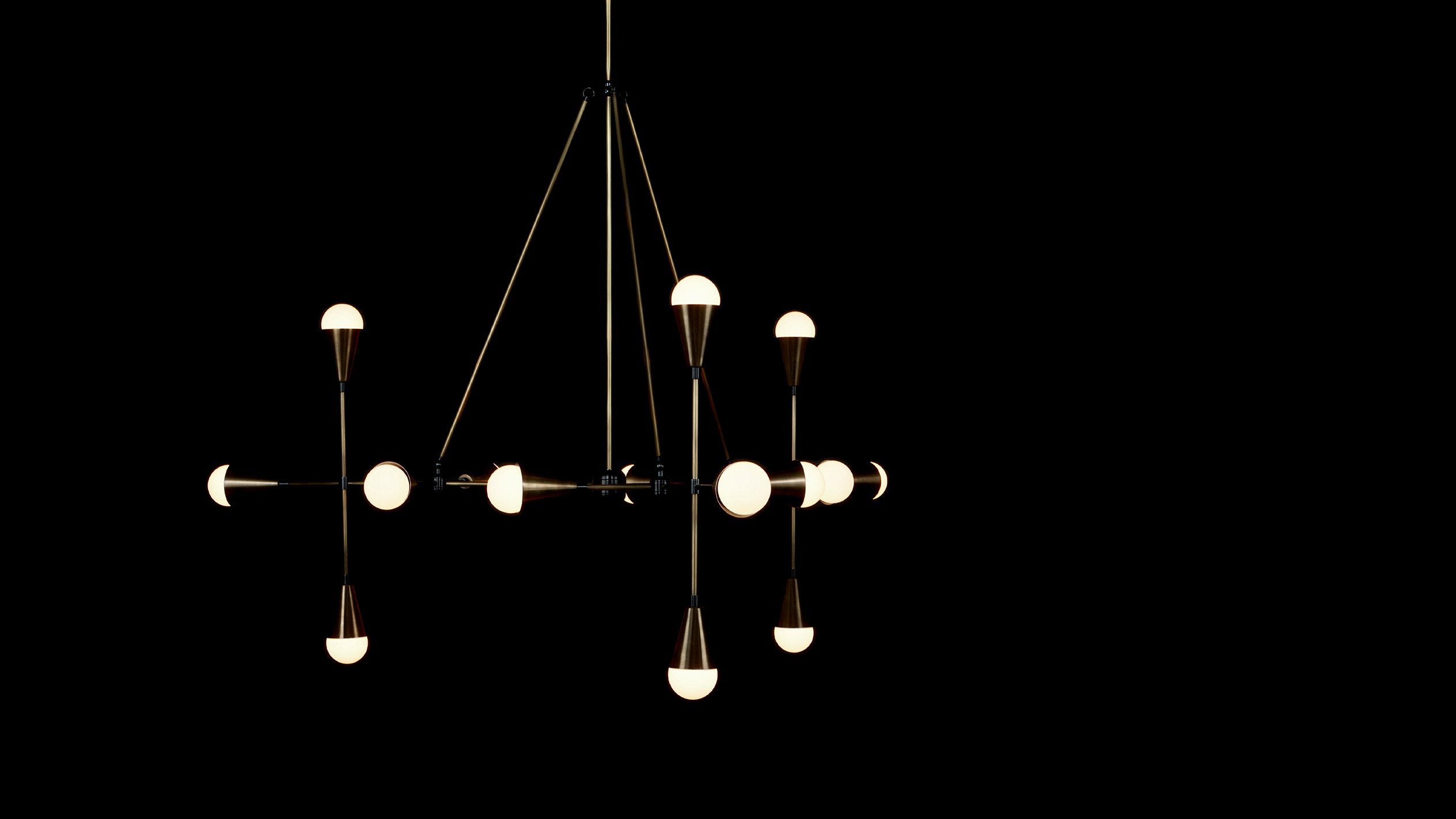 TRIAD : 15 ceiling pendant in Aged Brass and Blackened Brass finish, hanging against a black background. 