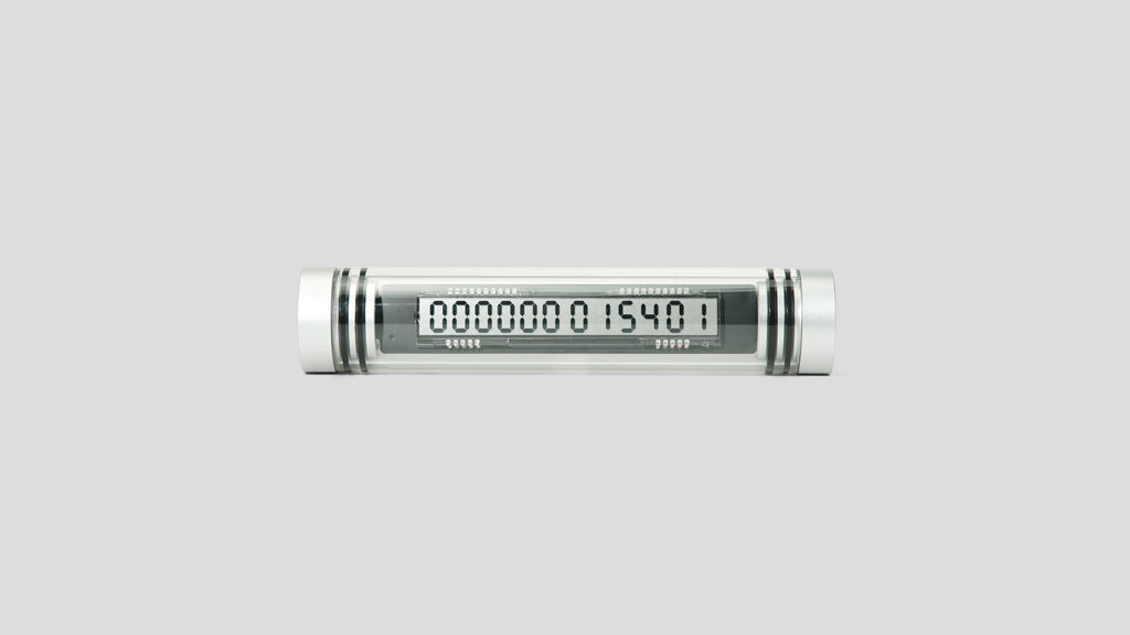 A transparent glass tube with aluminum end caps and a 12 digit seven segment display showing Time Since Launch.