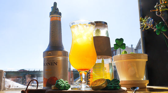 iced tea refresher on cutting board with gold coins and shamrocks