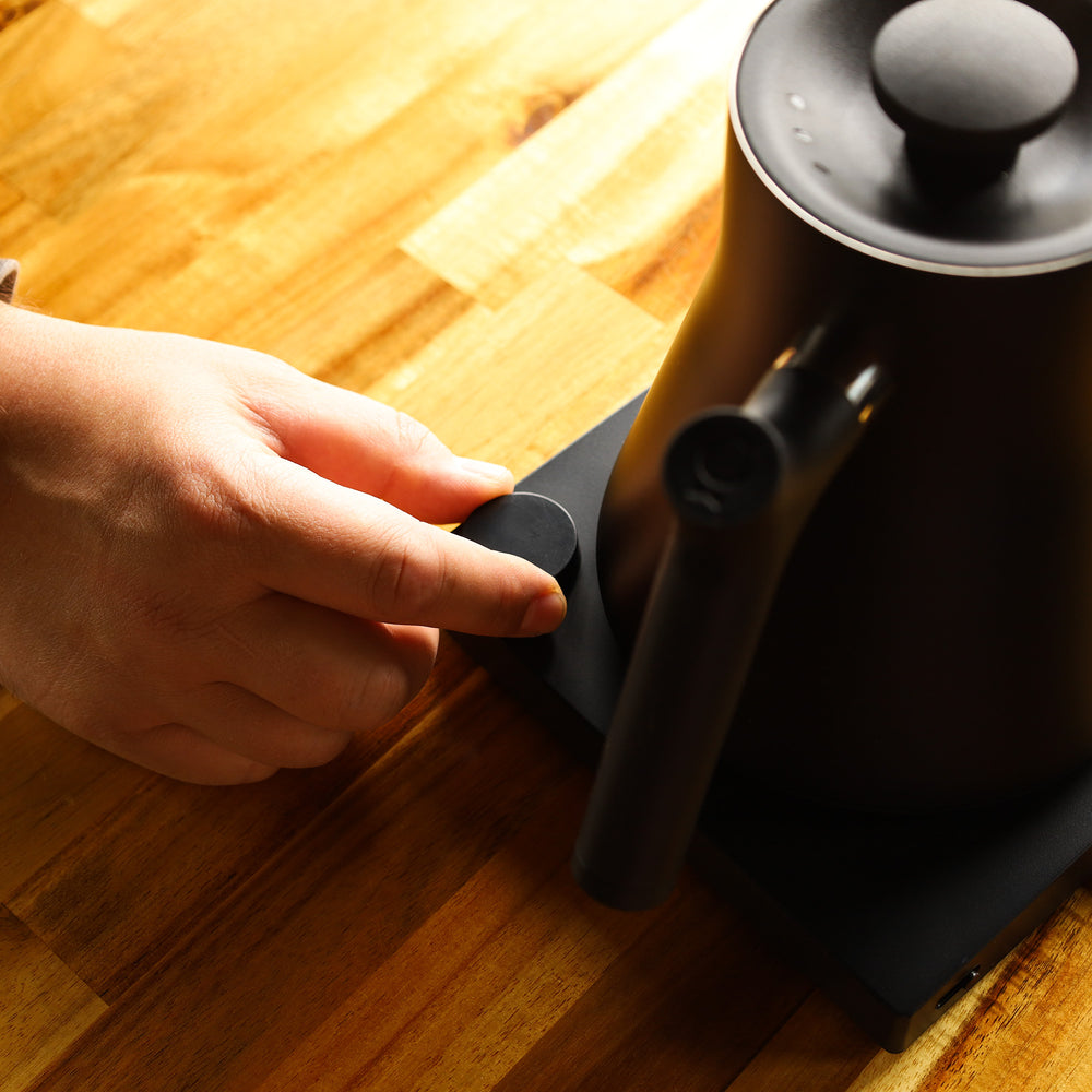 hand using an electric kettle