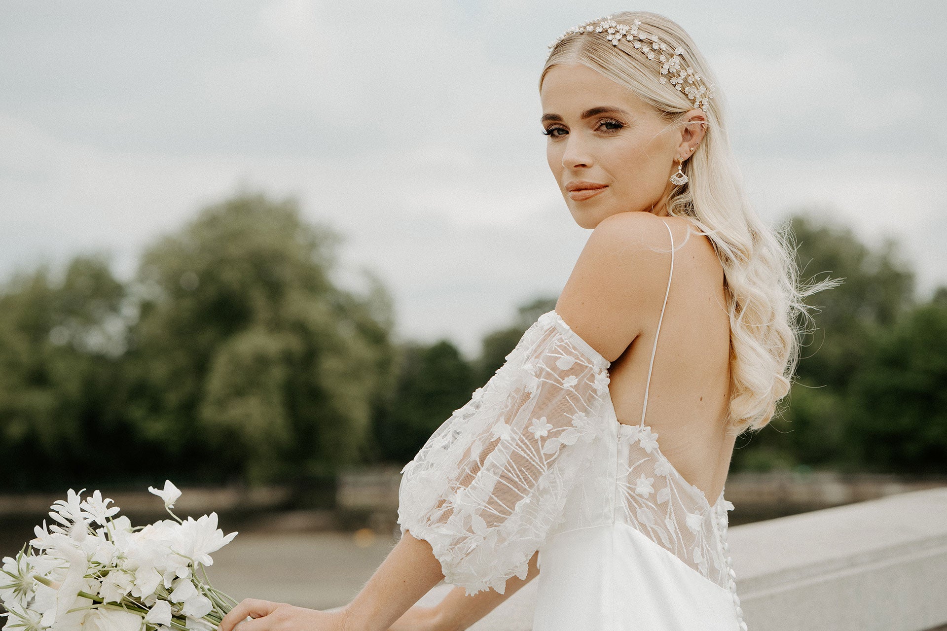 Our bride wearing the Florence Wedding Dress, featuring the eye-catching lace puffy sheer sleeves