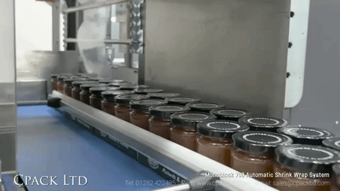Jars on shrink wrap conveyor