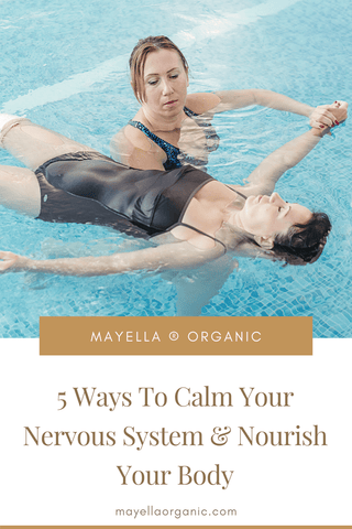 Pinterest image for this blog post. The photo in the top half is the same photo as above of the two women in a pool for watsu treatment. The bottom half is the name of the blog post in gold text that reads "5 Ways To Calm Your Nervous System and Nourish Your Body"