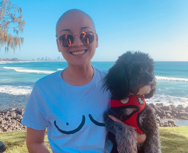 Lorena outdoors with her dog wearing a tshirt with breasts drawing on it