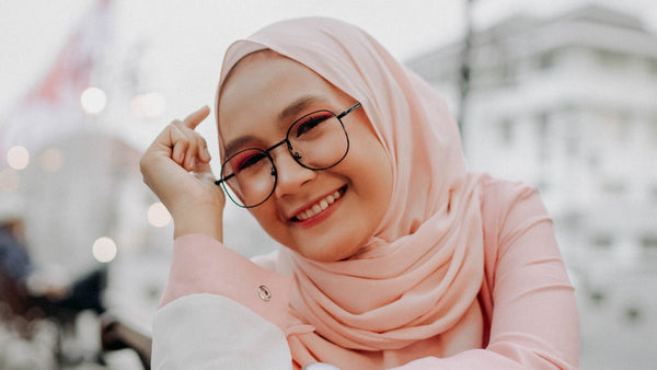 smiling woman wearing a soft pink hijab
