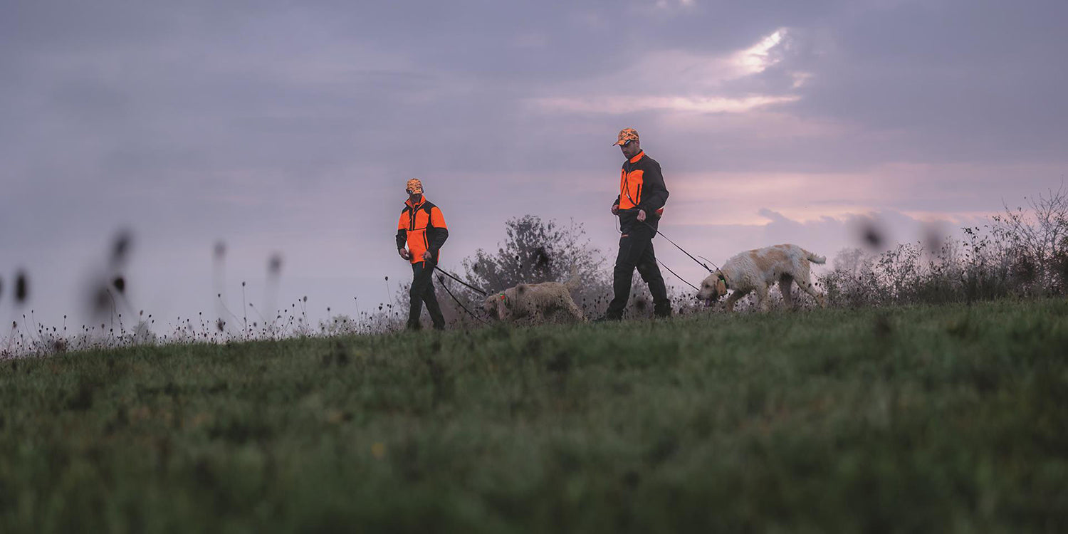 image of two canine handlers and two dogs equipped with garmin alpha 300