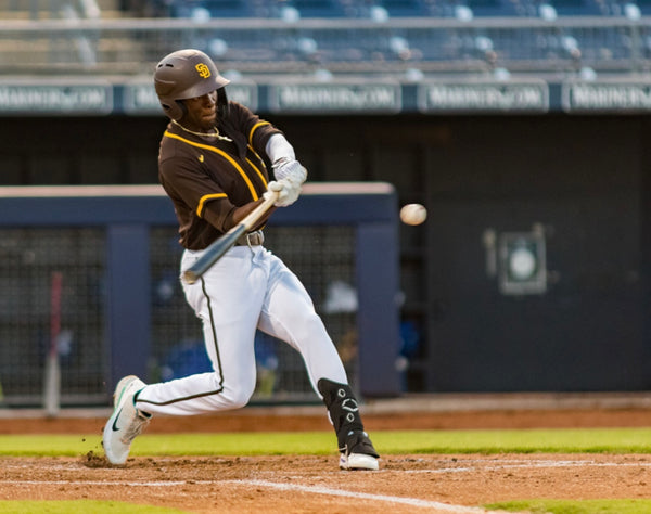 Justin Farmer from Guardian Baseball using a baseball bat in a minor league baseball game.