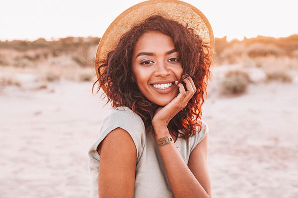 Woman with Blisslets nausea relief bands for vestibular migraine in beach