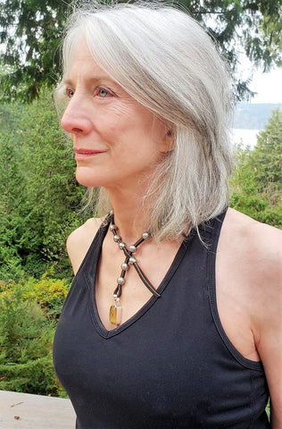 Beautiful silver haired woman wearing rudyblu leather and steel wrap necklace