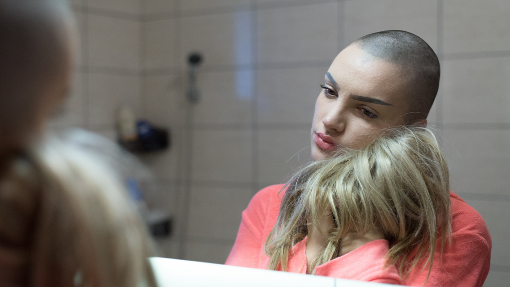Cancer patient in front of mirror with her wig | Chavie Russell Wigs