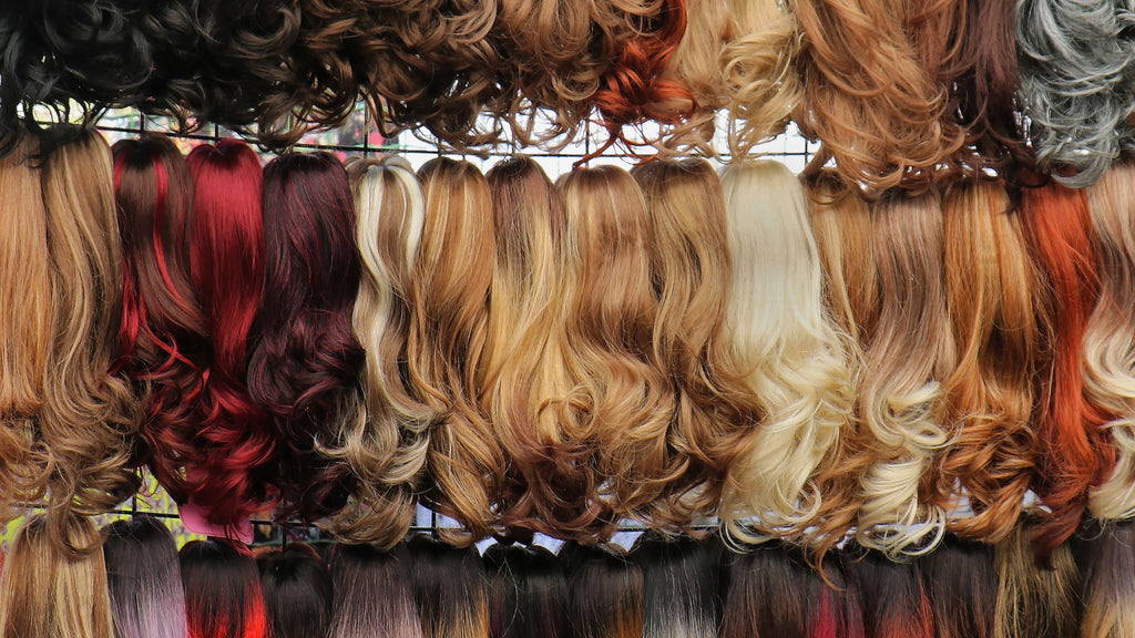 Row of assorted human hair wigs