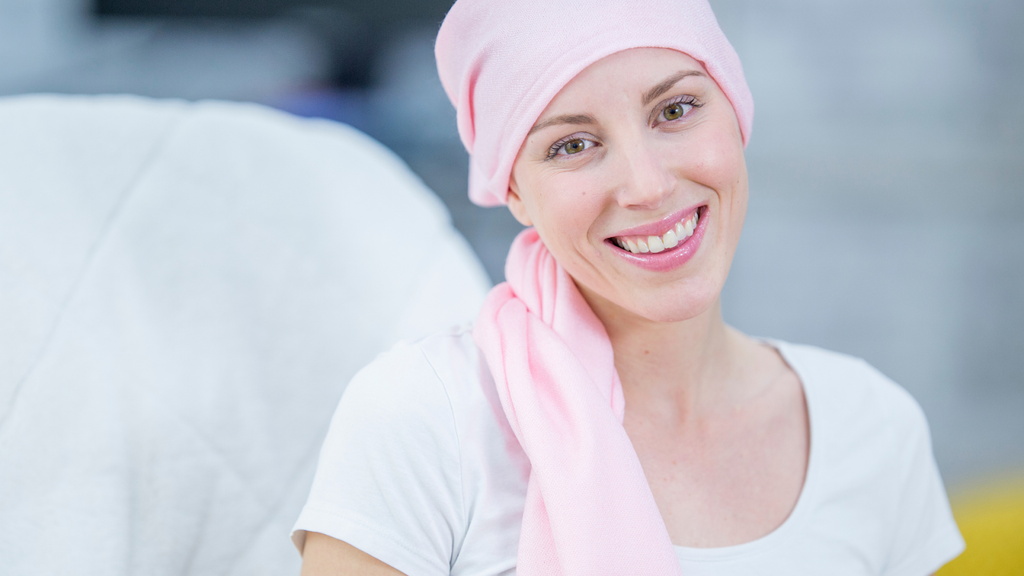 smiling woman with pink hair wrap 