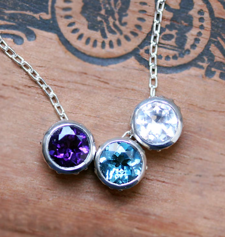 three round birthstones bezel set into sterling silver bezels that slide on a silver link chain