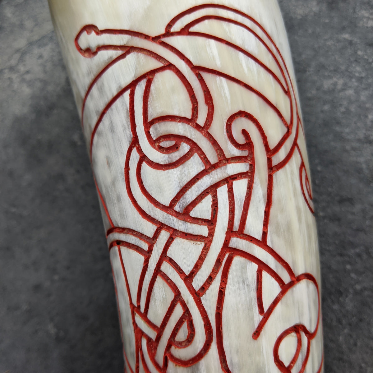 Hand drawn and carved red knot work horn