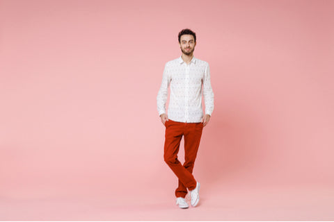 man in untucked white dress shirt with pink background