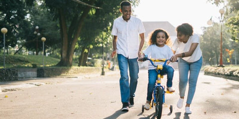 parents and kid on cycle