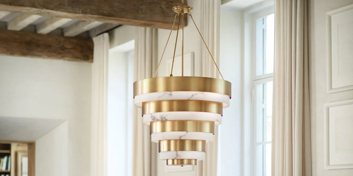 Gold & Alabaster chandelier hanging from a beamed ceiling | New in Lighting