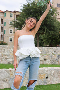 girl wearing strapless white peplum top