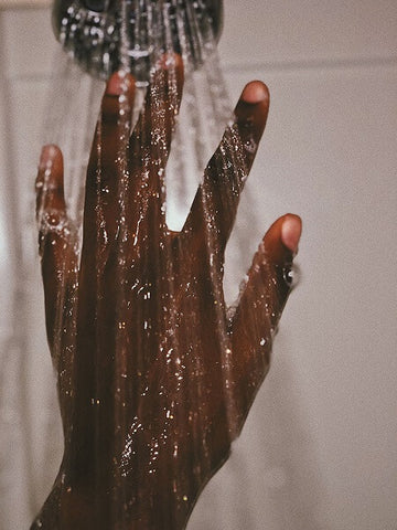 Hand in a cold water shower