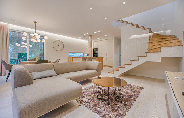 L-shaped light brown sofa in a white and brown-coloured living room