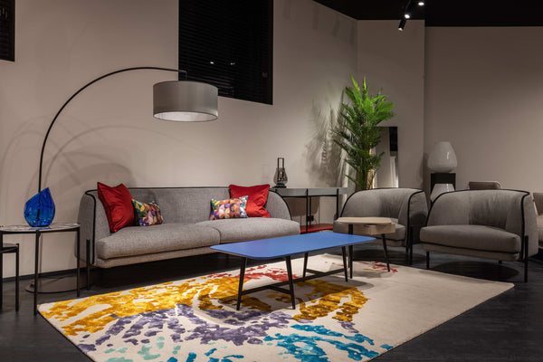 Grey sofa with cushions, lampshade and a rectangular-shaped table