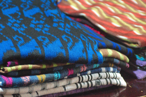 Stack of colourful Ikat fabrics