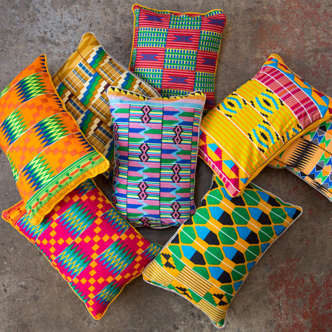 Colourful Kente cushions from Ghana laying on the floor