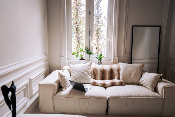 Patterned fabric and neutral cushions on a cream sofa