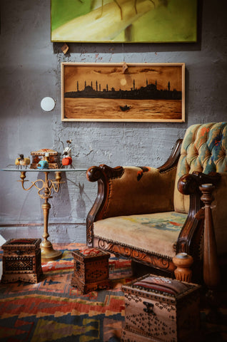 Colourful tufted couch with a landscape painting