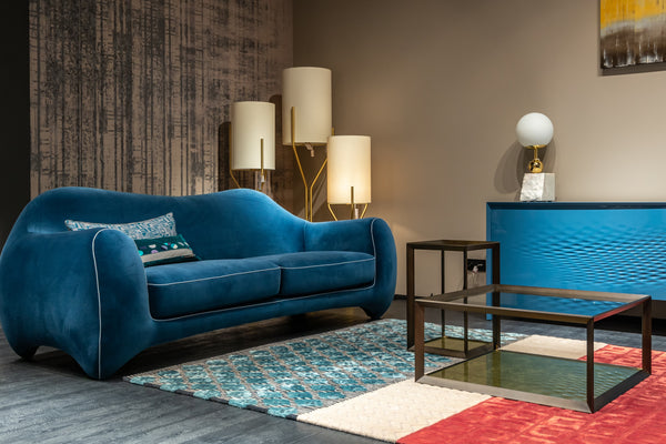 Blue sofa with a patterned cushion and three lampshades