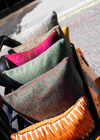 Colourful Ikat and Harris Tweed Fabrics Neatly Arranged on a Cart